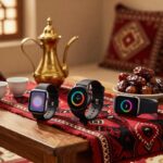 ثلاث ساعات ذكية حديثة على مفرش سدو أحمر في مجلس سعودي بجانب دلة نحاسية وفناجين قهوة وتمر